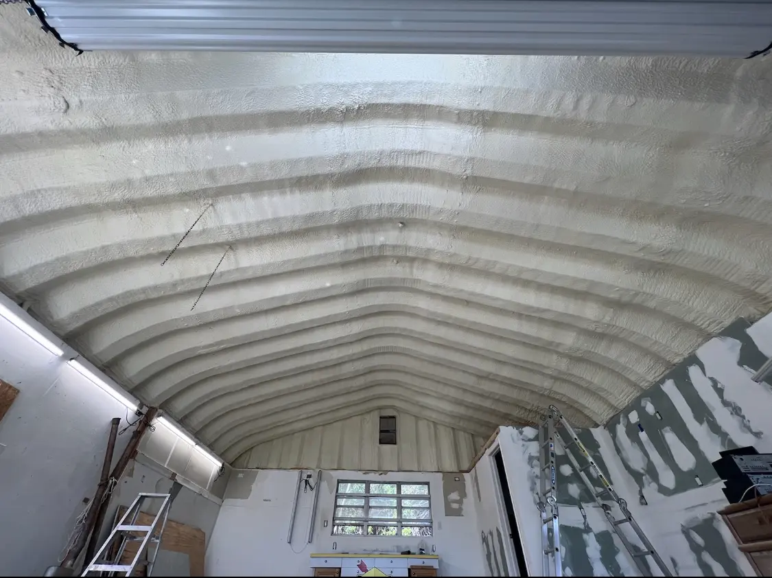 Spray polyurethane foam applied to the underside of a metal roof deck in Laurel Hill